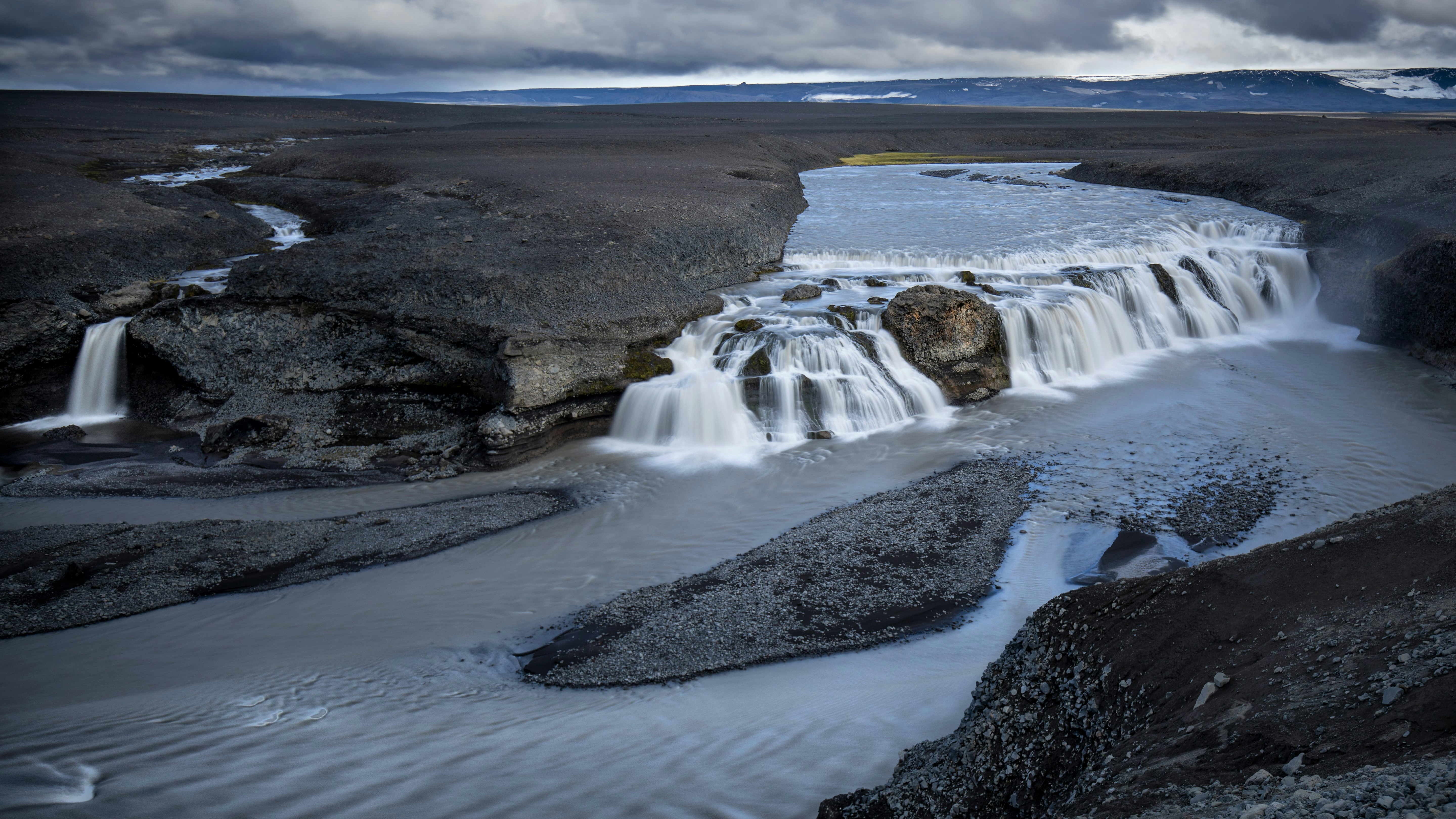 water falls under gray cloudy sky during daytime